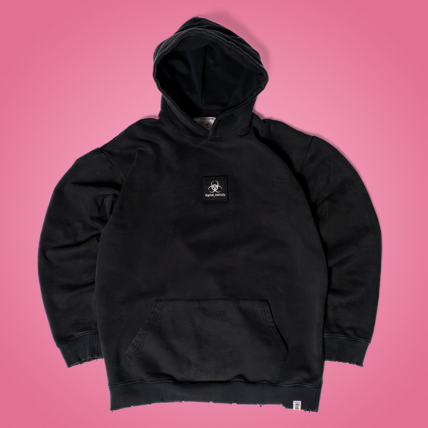 Dark gray acid wash hoodie featuring a ‘digital_toxicity’ patch on the chest, oversized fit with dropped shoulders and cozy fleece lining – glitchcore-inspired streetwear from Grater Things.