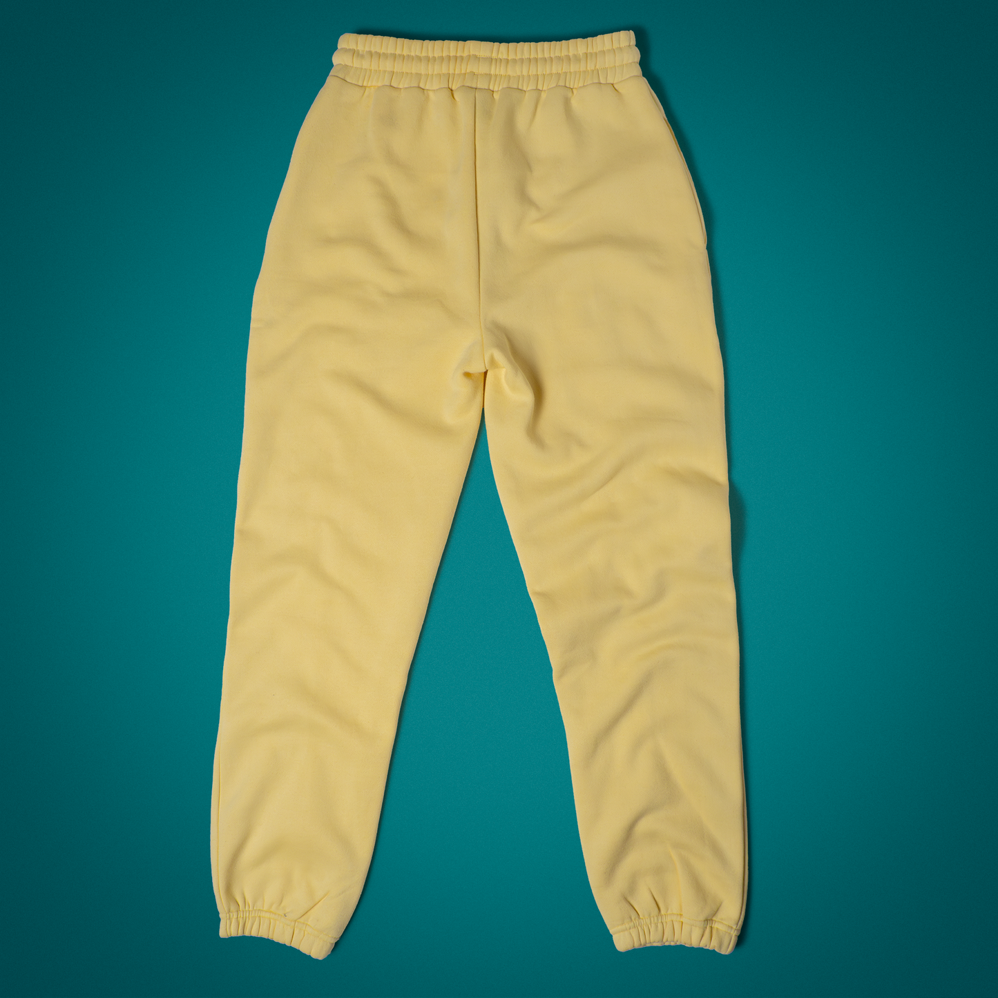 Back view of the Mac n Beam Sweatpants buttery yellow fleece with a clean, pocketless silhouette and a cozy elastic waistband that hugs just right.