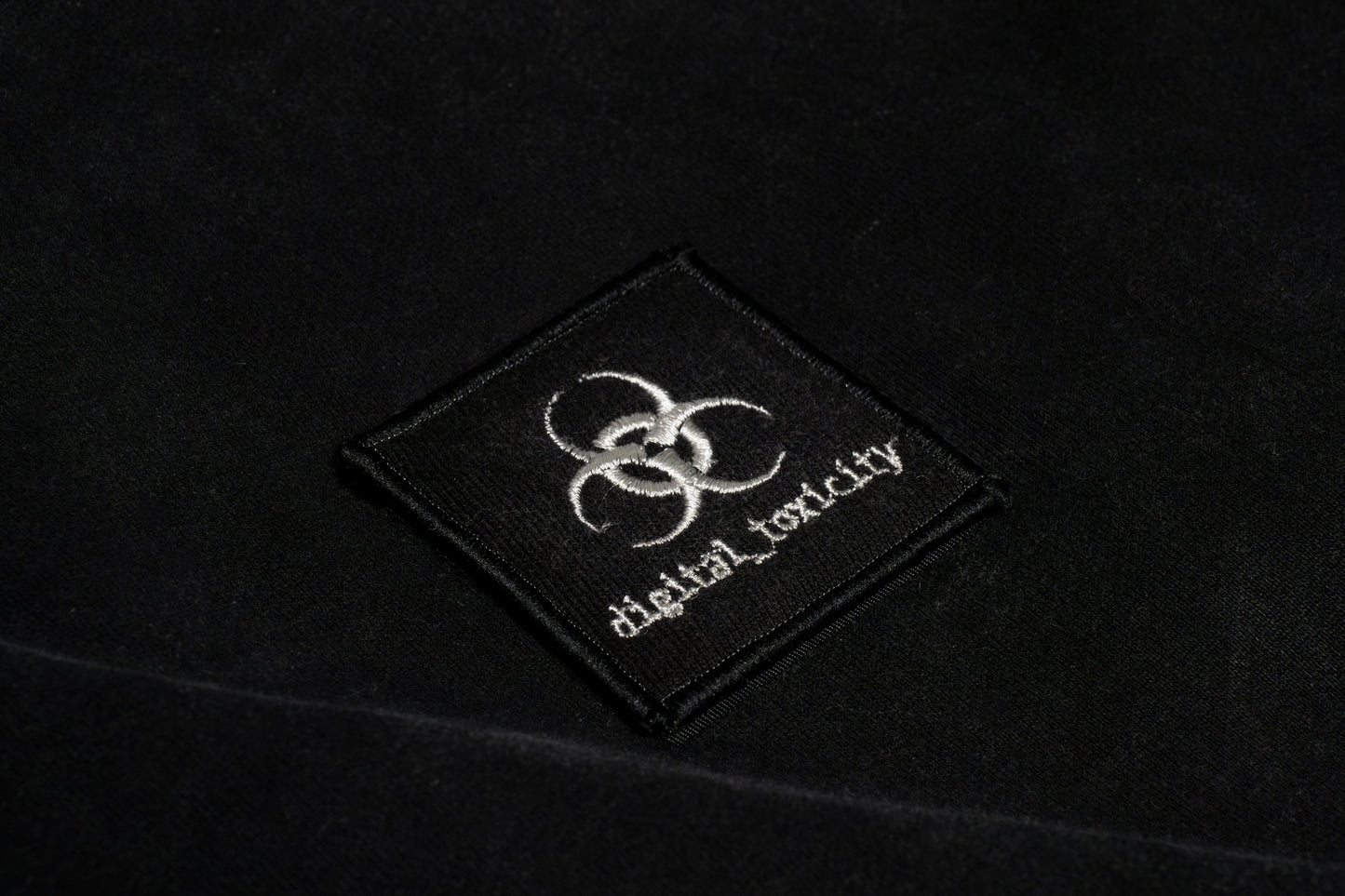 The digital_toxicity logo fuses glitchy edge with clean minimalism a sharp, distorted typeface that looks like it's been pulled from a corrupted file, giving off major cyber-cheesecore energy. Bold, a little chaotic, and unmistakably wired.