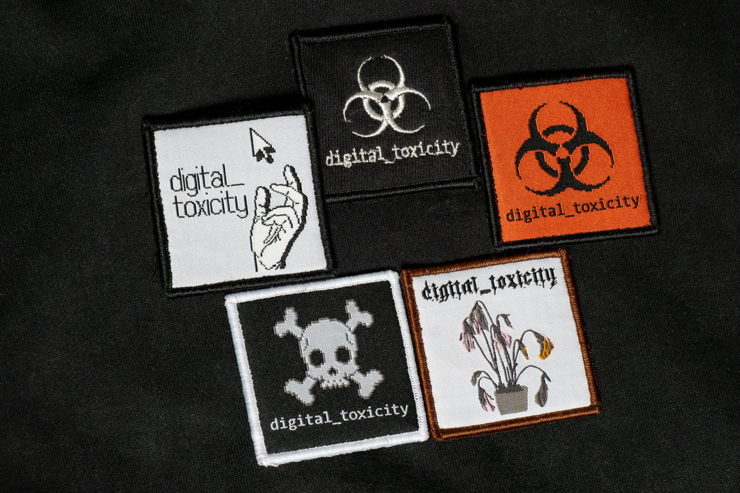 The digital_toxicity hoodie features five distinct embroidered logos of Digital Toxicity, each with its own glitchy, cyberpunk-inspired design layered across the back like corrupted code, making a bold statement in every thread.