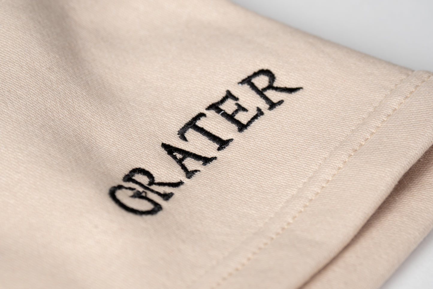 A crisp close up of confidence. These sandy sweatshorts feature bold black “GRATER” embroidery near the hem, clean, cheeky and unmistakably yours.