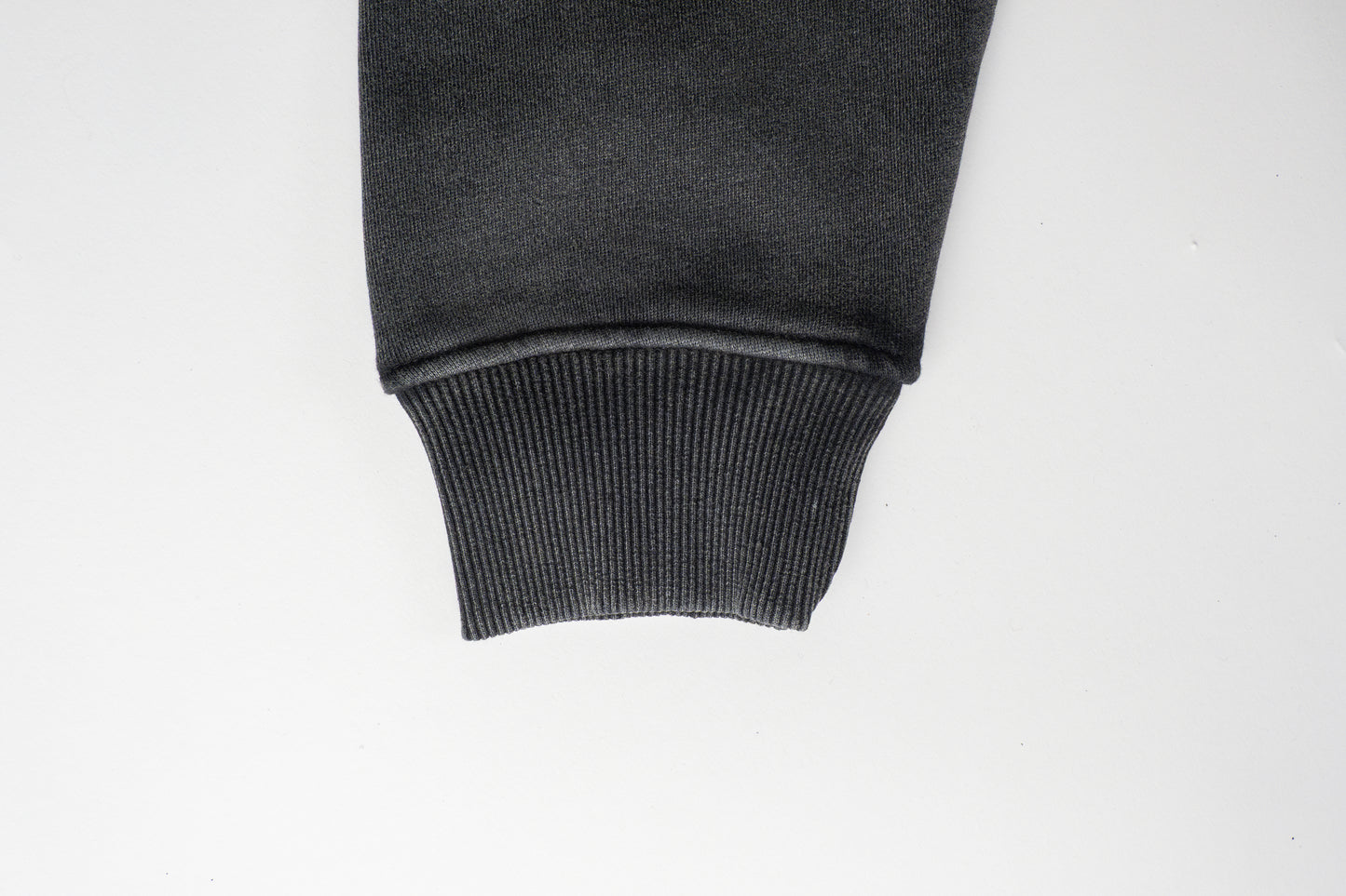 The sleeve of the Smoked Gouda Oversized Hoodie is generously cut for a relaxed, slouchy fit. Finished with a thick ribbed cuff, it offers a cozy feel while adding just the right amount of structure to balance the oversized silhouette.