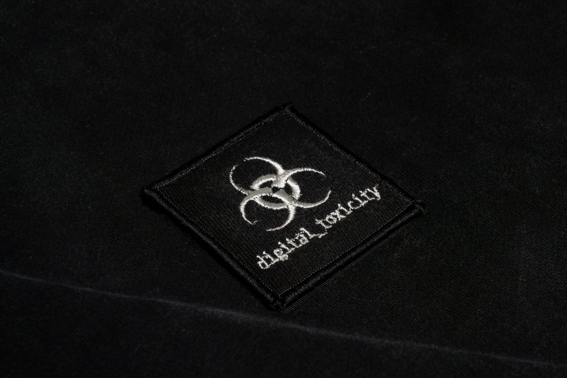 The digital_toxicity logo fuses glitchy edge with clean minimalism  a sharp, distorted typeface that looks like it's been pulled from a corrupted file, giving off major cyber-cheesecore energy. Bold, a little chaotic, and unmistakably wired.