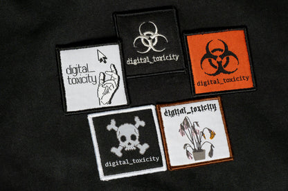 The digital_toxicity hoodie features five distinct embroidered logos of Digital Toxicity, each with its own glitchy, cyberpunk-inspired design layered across the back like corrupted code, making a bold statement in every thread.